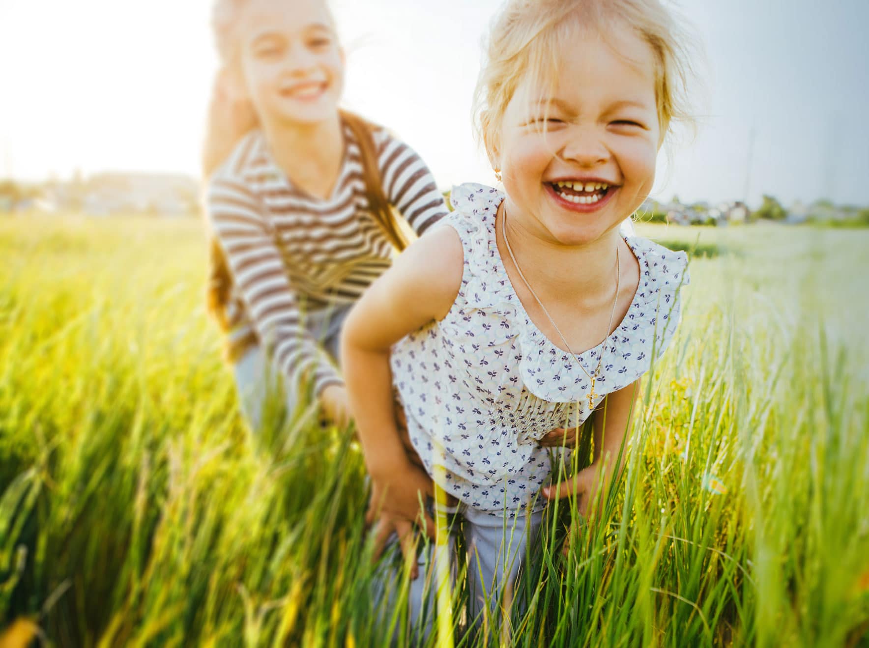 two children smiling outside Northfield Pediatric Dentistry in Denver, CO